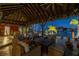 Waterfront covered patio boasts comfortable seating, providing a relaxing outdoor space with picturesque views at 351 S Julia Cir, St Pete Beach, FL 33706