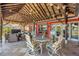 Beautiful covered waterfront patio has tile flooring and a seating and dining area at 351 S Julia Cir, St Pete Beach, FL 33706