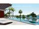 Modern pool with in-water seating, spa and stunning waterfront views in this rendering at 351 S Julia Cir, St Pete Beach, FL 33706