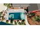 Aerial view of the backyard pool area with spa and bay views in this virtual rendering at 351 S Julia Cir, St Pete Beach, FL 33706