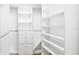 Spacious walk-in closet with custom shelving providing substantial storage at 351 S Julia Cir, St Pete Beach, FL 33706