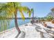 Secluded waterfront with a sandy beach area and Adirondack chairs at 351 S Julia Cir, St Pete Beach, FL 33706