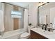 Well-lit bathroom featuring modern fixtures, stylish mirror, and tiled shower and tub at 3540 Emerson S Ave, St Petersburg, FL 33711