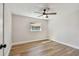 Empty bedroom has neutral walls, hardwood floors, a ceiling fan, and window with neighborhood views at 3540 Emerson S Ave, St Petersburg, FL 33711