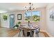 Dining area with modern lighting fixture and view of backyard through large window at 3540 Emerson S Ave, St Petersburg, FL 33711