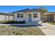 Charming home featuring white stone facade, a light blue door, and manicured landscaping at 3540 Emerson S Ave, St Petersburg, FL 33711