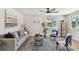 Bright living room features modern decor, a ceiling fan, and warm-toned wood flooring at 3540 Emerson S Ave, St Petersburg, FL 33711