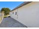 Side yard with fence, concrete walkway and home exterior with multiple windows at 3540 Emerson S Ave, St Petersburg, FL 33711