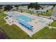 Aerial view of a sparkling community pool with ample seating, sunshades, and a well-maintained deck area at 36624 Kay Ave Ave, Zephyrhills, FL 33542