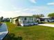 Charming single-story home with well-maintained lawn, landscaping and carport at 36624 Kay Ave, Zephyrhills, FL 33542