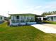 Charming single-story home featuring a covered front porch and manicured lawn at 36624 Kay Ave, Zephyrhills, FL 33542