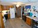 Well-lit kitchen featuring wood cabinets, white refrigerator, and an adjacent breakfast bar area at 36624 Kay Ave, Zephyrhills, FL 33542