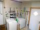 Practical laundry room equipped with washer, dryer and shelving for extra storage at 36624 Kay Ave, Zephyrhills, FL 33542