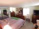 A commodious main bedroom with natural light, dresser storage, and neutral decor at 36624 Kay Ave, Zephyrhills, FL 33542