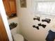 Compact powder room featuring vintage wall decor and woodgrain cabinetry at 36624 Kay Ave, Zephyrhills, FL 33542