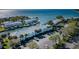 Scenic aerial view showcases waterfront condos with private boat docks, lush landscaping, and open water access at 5196 Beach Se Dr # B, St Petersburg, FL 33705