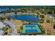 Aerial view of tennis courts next to a scenic lake surrounded by lush landscaping and beautiful homes at 5196 Beach Se Dr # B, St Petersburg, FL 33705