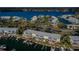 Aerial view of waterfront condos with private boat docks, lush trees, and tranquil water views at 5196 Beach Se Dr # B, St Petersburg, FL 33705