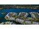 Aerial view of a waterfront condo community with boat docks, lush landscaping, and a serene water backdrop at 5196 Beach Se Dr # B, St Petersburg, FL 33705