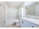 Clean bathroom features a white vanity with marble countertop and shower-tub combo at 5196 Beach Se Dr # B, St Petersburg, FL 33705