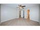 Bedroom features tile flooring, ceiling fan, and doorways to the bathroom and closet at 5196 Beach Se Dr # B, St Petersburg, FL 33705