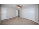 Bedroom features tile flooring, ceiling fan, closet, and two doors at 5196 Beach Se Dr # B, St Petersburg, FL 33705