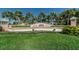 Waterside community entrance featuring a well-maintained sign, landscaping, and lush green grass at 5196 Beach Se Dr # B, St Petersburg, FL 33705