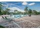 Community pool with lounge chairs, tiled deck, and tropical landscaping at 5196 Beach Se Dr # B, St Petersburg, FL 33705
