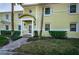 Exterior view of condo features a welcoming front entrance with classic architectural details and manicured landscaping at 5196 Beach Se Dr # B, St Petersburg, FL 33705