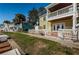 Exterior rear view of a waterfront condo, featuring a patio, balcony and fenced yard space at 5196 Beach Se Dr # B, St Petersburg, FL 33705