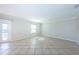 Bright living room features neutral paint, tile flooring, and natural light at 5196 Beach Se Dr # B, St Petersburg, FL 33705