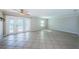 Spacious living room features neutral tile flooring, abundant natural light, and access to a private outdoor space at 5196 Beach Se Dr # B, St Petersburg, FL 33705