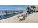 Relaxing pool deck area with lounge chairs and a pier leading to the beautiful water at 5196 Beach Se Dr # B, St Petersburg, FL 33705