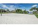 Picturesque beach volleyball court with fine white sand, palm trees, and waterfront views for leisurely enjoyment at 5196 Beach Se Dr # B, St Petersburg, FL 33705
