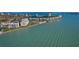 Stunning aerial view of condos by the water with beach access, pool, and lush landscaping at 6001 Bahia Del Mar Cir # 429, St Petersburg, FL 33715