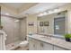 Bright bathroom features a tiled shower, vanity with granite counters, and framed mirror at 6001 Bahia Del Mar Cir # 429, St Petersburg, FL 33715
