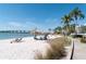 Calm beach area with lounge chairs, palm trees, and a view of the condo at 6001 Bahia Del Mar Cir # 429, St Petersburg, FL 33715