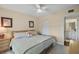 Bright main bedroom features a ceiling fan, tiled floors, closet, and ensuite bathroom at 6001 Bahia Del Mar Cir # 429, St Petersburg, FL 33715