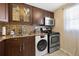 Kitchen with dark wood cabinets, modern appliances, and patterned backsplash at 6800 20Th N Ave # 309, St Petersburg, FL 33710