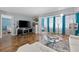 Cozy living room with hardwood flooring, sheer curtains, and views at 6800 20Th N Ave # 309, St Petersburg, FL 33710