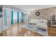 Bright living room featuring a brick accent wall, hardwood floors, and stylish decor at 6800 20Th N Ave # 309, St Petersburg, FL 33710
