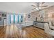 Spacious living room with brick accent wall, white sofa, and stylish décor at 6800 20Th N Ave # 309, St Petersburg, FL 33710