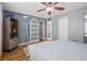Comfortable main bedroom features wood flooring, a barn door, and a view into the en-suite bathroom at 6800 20Th N Ave # 309, St Petersburg, FL 33710