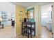 Nicely decorated hallway with adjacent kitchen, bathroom, writing desk, and beach themed decor at 6800 Sunset Way # 204, St Pete Beach, FL 33706