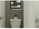 Bathroom featuring a toilet, grey accent wall, white subway tile and decorative accessories at 6834 E 115Th St, Palmetto, FL 34221