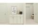 Clean hallway showcasing a stylish cabinet with drawers, decor items and interior doorframe at 6834 E 115Th St, Palmetto, FL 34221