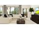 Bright living room features a neutral palette, large windows, and access to the outdoors at 6834 E 115Th St, Palmetto, FL 34221
