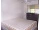 Spare bedroom showcasing a bed, dark dresser, and a window letting in natural light at 8455 112Th St # 202, Seminole, FL 33772