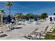 Community pool features lounge chairs, shaded tables and umbrellas on a sunny day at 8455 112Th St # 202, Seminole, FL 33772