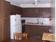 Functional kitchen offering brown cabinetry, white appliances, and adequate counter space at 8455 112Th St # 202, Seminole, FL 33772